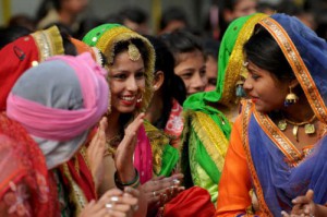Girls wearing traditional Panjabi dresses perform gidda during the Lohri celebrations at the Ramgarhia College for Girls in Ludhiana