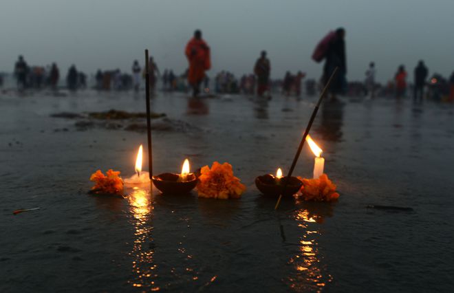 Hindu devotees take a holy dip and perform rituals at Gangasagar Island around 150 km south of Kolkata on January 15, 2016