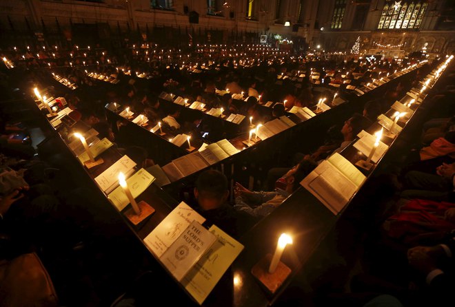 People attend a Christmas Eve mass at St. Paul's Cathedral in Kolkata on December 24, 2015