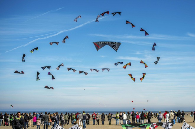 People fly kites during the 30th International Kite Festival in Berck-sur-Mer in northern France on April 12, 2016
