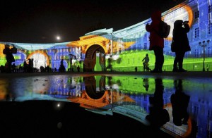 People watch a light show at the Dvortsovaya (Palace) square decorated for incoming New Year and Christmas celebration in St.Petersburg, Russia, on December 24, 2015