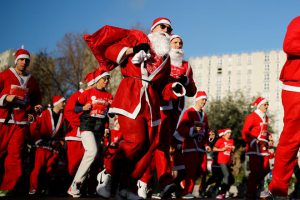 Runners dressed as Santa Claus take part in the 40th Christmas Corrida Race on the streets of Issy-les-Moulineaux, near Paris, France, December 11, 2016