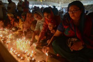 Sikh devotees light candles at the Golden Temple in Amritsar on October 17, 2016 during an event to mark the birth anniversary of the fourth Sikh Guru Ramdas.