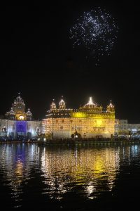 Sikh devotees watch a fireworks display at the Golden Temple in Amritsar on October 17, 2016 during an event to mark the birth anniversary of the fourth Sikh Guru Ramdas.