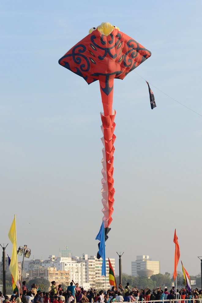 Spectators watch as a huge colourful kite is flown on the inaugural day of the International Kite Festival 2016 in Ahmedabad on January 10, 2016