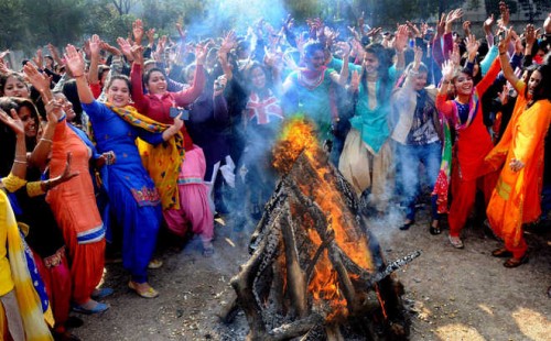 Students dance around a bonfire during the Lohri Cellebrations at Sri Guru Gobind Singh College for Women in Sector 26 Chandigarh