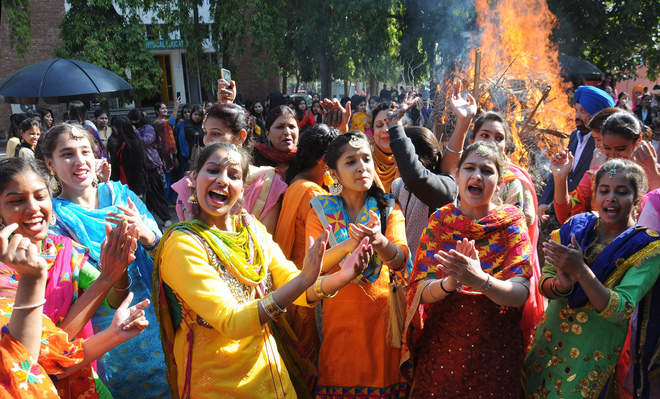 Students of GCG College, Sector 11, dance in a jubilant mood during Lohri, which marks the culmination of winter in many parts of northern India, in Chandigarh on January 13.