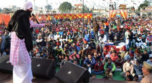 Sufi singer Kanwar Grewal performs during the Lohri Mela at the local grain market in Ludhiana