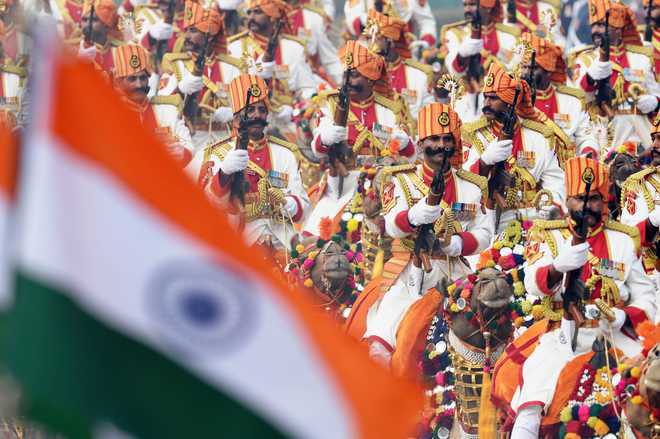 The Border Security Force's marching contingent ride camels during the Republic Day
