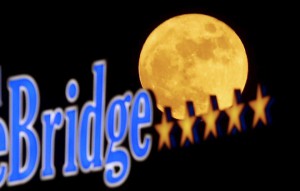 The full moon rises behind a five star hotel in Skopje, Macedonia, on December 25, 2015