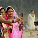 Women take a selfie at Maidan in Kolkata