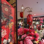 A couple shops artificial flowers for Lunar New Year decorations at a shopping mall in Kuala Lumpur, Malaysia on Monday. The Lunar New Year which falls on January 28 this year marks the Year of the Rooster in the Chinese calendar