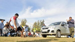 A man pulls a car with his teeth on the inaugural day of Kila Raipur Rural Sports Festival at village Kila Raipur in Ludhiana