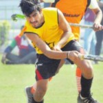 A players hits the ball during a hockey match
