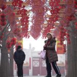 A woman visits a park in Beijing on Tuesday. Chinese New Year, known locally as the spring festival, falls on January 28 this year