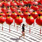 A woman walks under traditional Chinese lanterns decorated at the Thean Hou temple in Kuala Lumpur