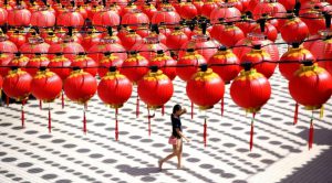 A woman walks under traditional Chinese lanterns decorated at the Thean Hou temple in Kuala Lumpur