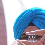 An artist Gurpreet Singh pays his tribute to martyr Shaheed Bhagat Singh, Rajguru and Sukhdev by making a tiny paper miniature at Jallianwala Bagh, Amritsar