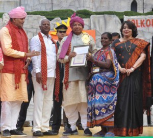 Governor Kaptan Singh Solanki gives an award to an artisan at the closing ceremony of the Surajkund International Crafts Mela in Faridabad