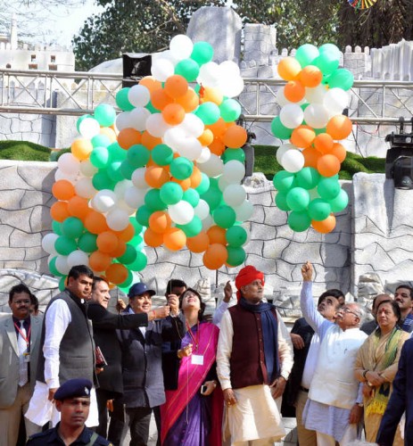 Jharkhand artistes watch Chief Minister Manohar Lal Khattar releasing baloons in the air marking the beginning of the Surajkund Crafts Mela in Faridabad