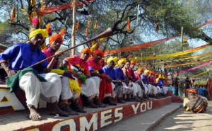 Jharkhand artistes watch Chief Minister Manohar Lal Khattar releasing baloons in the air marking the beginning of the Surajkund Crafts Mela in Faridabad