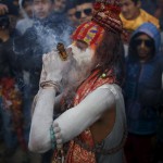 A Hindu holy man, or sadhu, smeared with ashes smokes marijuana in a chillum during the Shivaratri festival on the premises of Pashupatinath Temple in Kathmandu, Nepal, March 7, 2016. Hindu holy men from Nepal and India come to this temple to take part in the Maha Shivaratri festival. Celebrated by Hindu devotees all over the world, Shivaratri is dedicated to Lord Shiva, and holy men mark the occasion by praying, smoking marijuana or smearing their bodies with ashes.