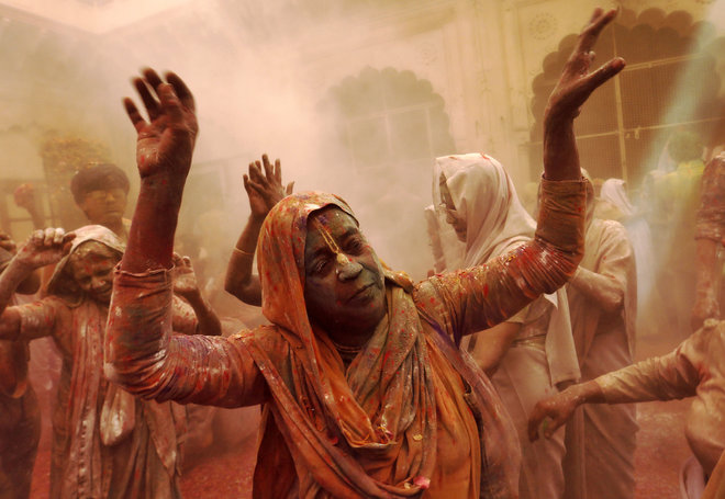A widow daubed in colours dances merrily during Holi celebrations. The event was organised by an NGO Sulabh International at a temple in Vrindavan, Uttar Pradesh