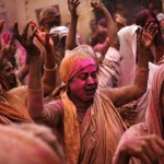 A widow sings religious songs during Holi celebrations at a temple in Vrindavan, Uttar Pradesh