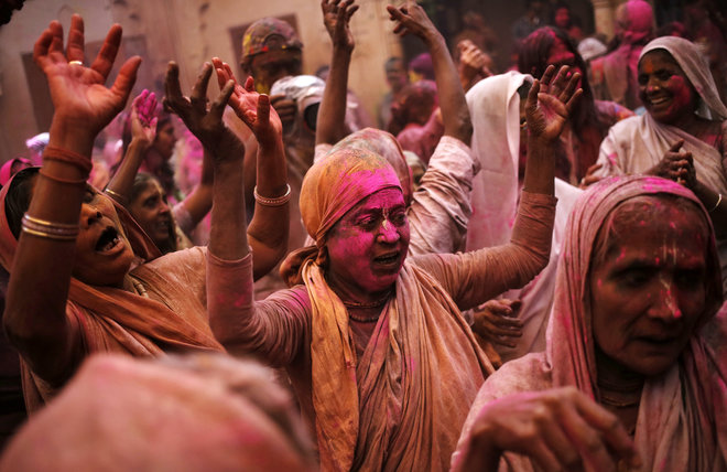 A widow sings religious songs during Holi celebrations at a temple in Vrindavan, Uttar Pradesh