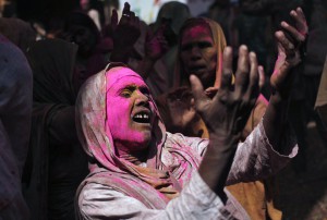 A widow sings religious songs during Holi celebrations at a temple in Vrindavan, Uttar Pradesh