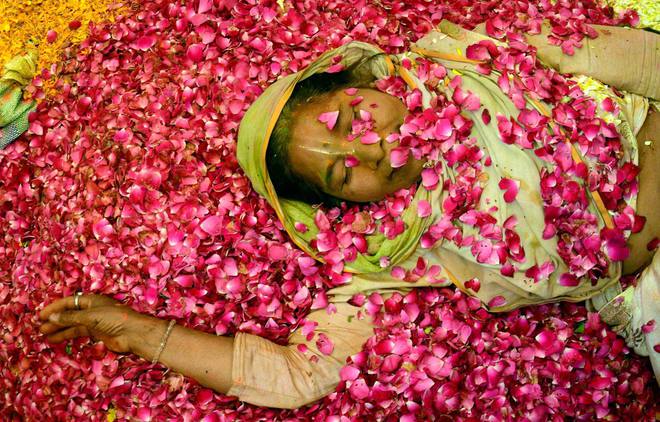 A widow takes part in flower Holi celebrations at Gopinath Temple Vrindavan in Uttar Pradesh