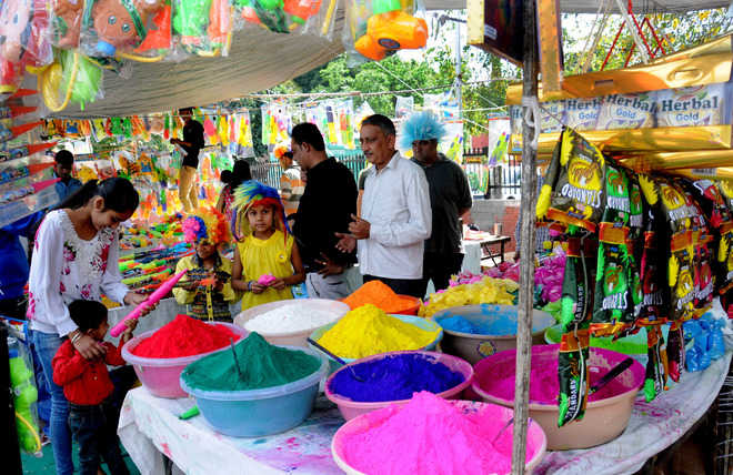 Children buy colours and water guns from a stall in Sector 22, Chandigarh