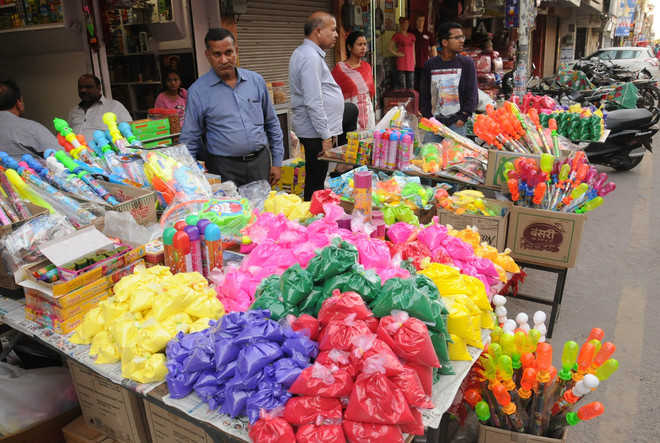Colours and waterguns on display at a shop on the eve of Holi in Sirki Bazaar, Bathinda