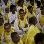 Hindu disciples watch participants performing a dance during the World Culture Festival on the banks of the river Yamuna in New Delhi on March 12, 2016