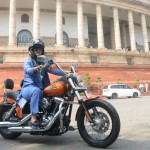 Ranjeet Ranjan, Lok Sabha MP from Supaul (Bihar), rides a Harley Davidson bike at Parliament in New Delhi on International Women's Day