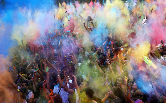 Revellers take part in the Monsoon Holi Madrid festival in Madrid, Spain, on August 13, 2016.