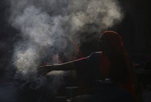 Smoke rises as a devotee sit next to a fire during the Shivaratri festival at the premises of Pashupatinath Temple in Kathmandu, Nepal, March 7, 2016. Hindu holy men from Nepal and India come to this temple to take part in the Maha Shivaratri festival. Celebrated by Hindu devotees all over the world, Shivaratri is dedicated to Lord Shiva, and holy men mark the occasion by praying, smoking marijuana or smearing their bodies with ashes.
