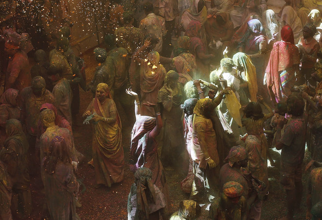 Widows daubed in colours dance as they take part in Holi celebrations at a temple in Vrindavan, Uttar Pradesh