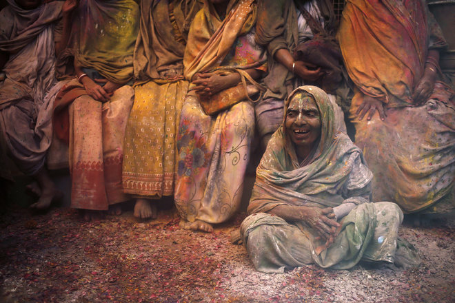 Widows take a break during Holi celebrations at a temple in Vrindavan, Uttar Pradesh