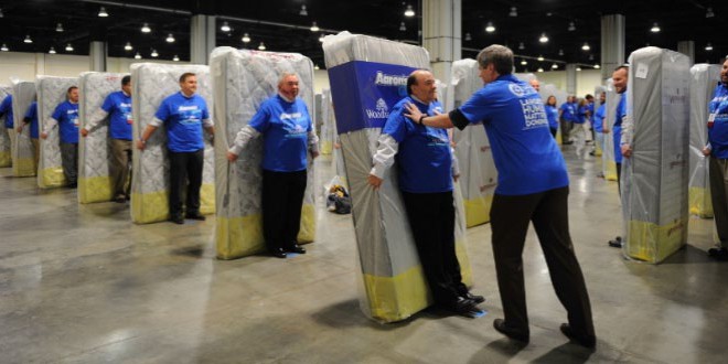 Largest human mattress dominoes: Aaron's breaks record