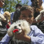 A child holds his dog during the Saint Lazarus festival on the Saint Lazarus festival on March 13 at the Santa Maria Magdalena parish in Masaya