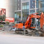 A heavy machine removes an encroachment from the Batala Road in front of the Celebration Mall in Amritsar