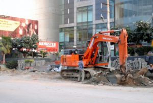 A heavy machine removes an encroachment from the Batala Road in front of the Celebration Mall in Amritsar