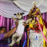 A man brings his fancy dressed dog to be blessed during the Saint Lazarus festival on March 13 at the Santa Maria Magdalena parish in Masaya