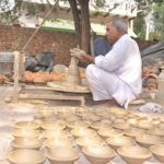 A potter makes earthen diyas in Jhajjar