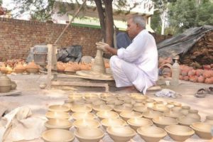 A potter makes earthen diyas in Jhajjar
