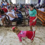 A woman holds her fancy dressed dog during the Saint Lazarus festival on March 13 at the Santa Maria Magdalena parish in Masaya Nicaragua