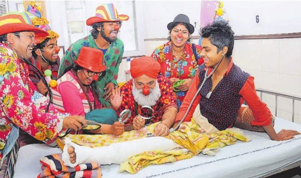 Artistes dressed as clowns entertain a patient at the GMSH Sector 16 in Chandigarh