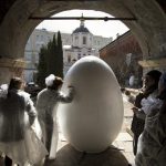 Children paint a huge symbolic egg in preparation for Orthodox Easter, after the Palm Sunday mass at the St. Peter's Cathedral in the High-Petrovsky monastery in Moscow, Russia