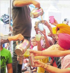 Devotees have sweetened water on the occasion of Baisakhi at Gurdwara Gau Ghat, Ludhiana